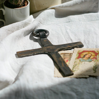 An interesting French antique artisan made Crucifix made from iron and painted black. On one side the metal has worn away in places giving this piece a pleasing patina of age. There's a hanging loop so it's ready to hang in your home.

We guesstimate this piece to be over 100 years old.