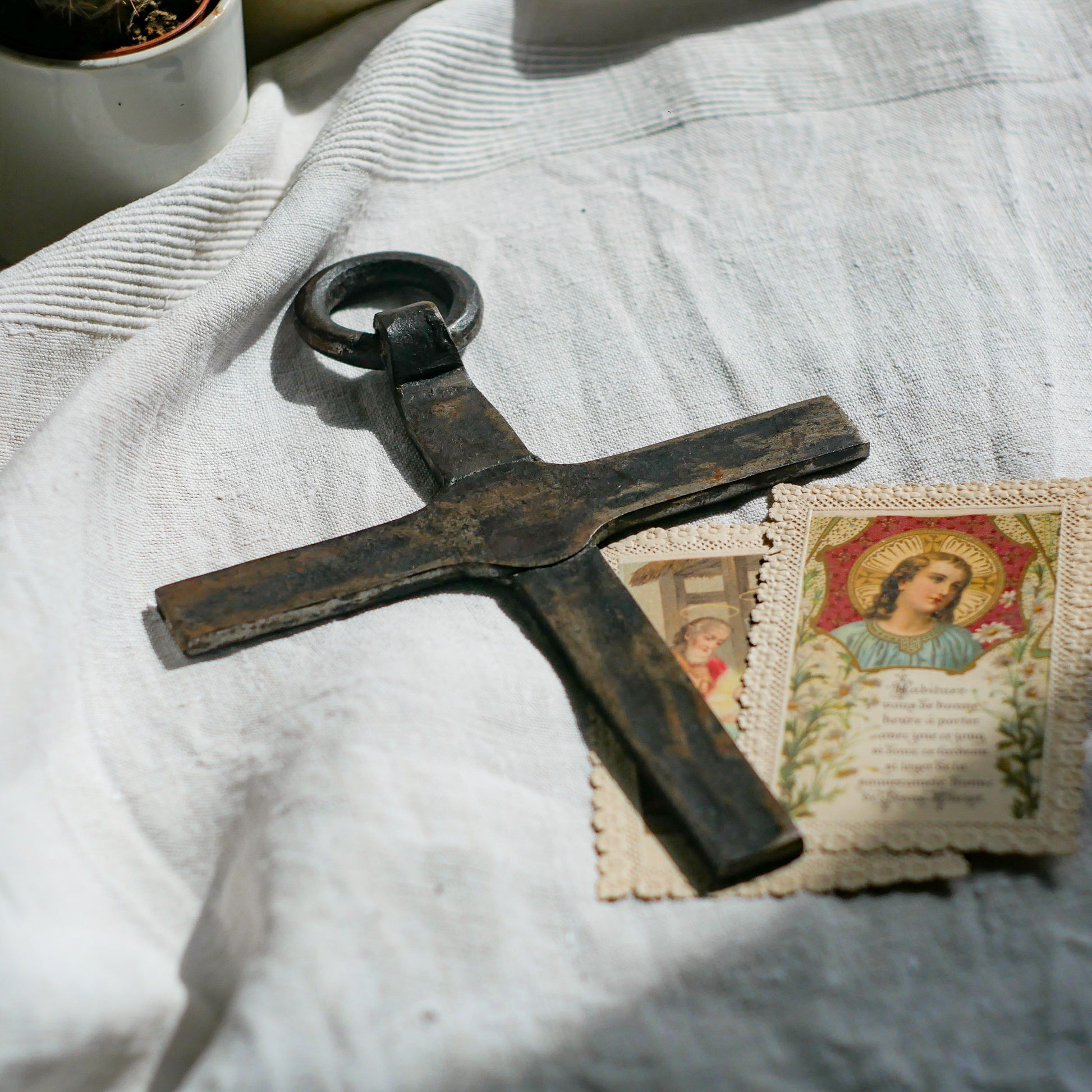 An interesting French antique artisan made Crucifix made from iron and painted black. On one side the metal has worn away in places giving this piece a pleasing patina of age. There's a hanging loop so it's ready to hang in your home.

We guesstimate this piece to be over 100 years old.