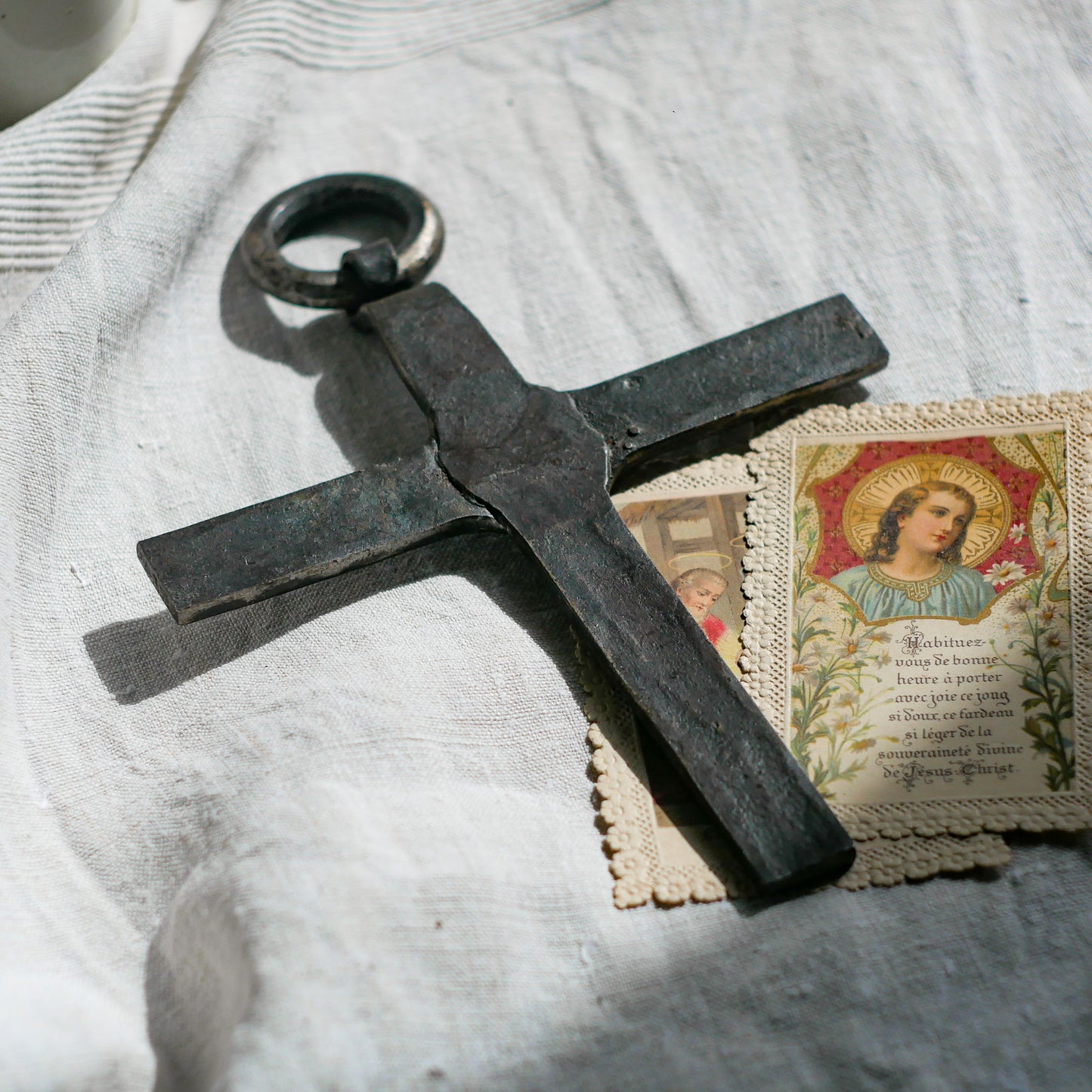 An interesting French antique artisan made Crucifix made from iron and painted black. On one side the metal has worn away in places giving this piece a pleasing patina of age. There's a hanging loop so it's ready to hang in your home.

We guesstimate this piece to be over 100 years old.