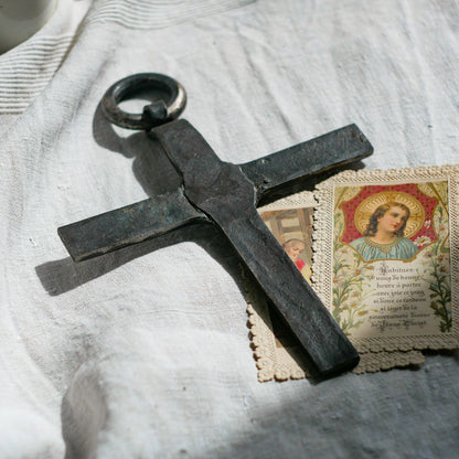 An interesting French antique artisan made Crucifix made from iron and painted black. On one side the metal has worn away in places giving this piece a pleasing patina of age. There's a hanging loop so it's ready to hang in your home.

We guesstimate this piece to be over 100 years old.