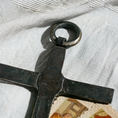 An interesting French antique artisan made Crucifix made from iron and painted black. On one side the metal has worn away in places giving this piece a pleasing patina of age. There's a hanging loop so it's ready to hang in your home.

We guesstimate this piece to be over 100 years old.