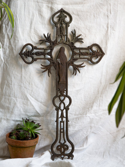 A large French antique crucifix in cast or wrought iron, featuring a figure of the Madonna at its center. Likely once part of a larger architectural structure, this rare piece carries visible signs of age and long exposure to the elements.