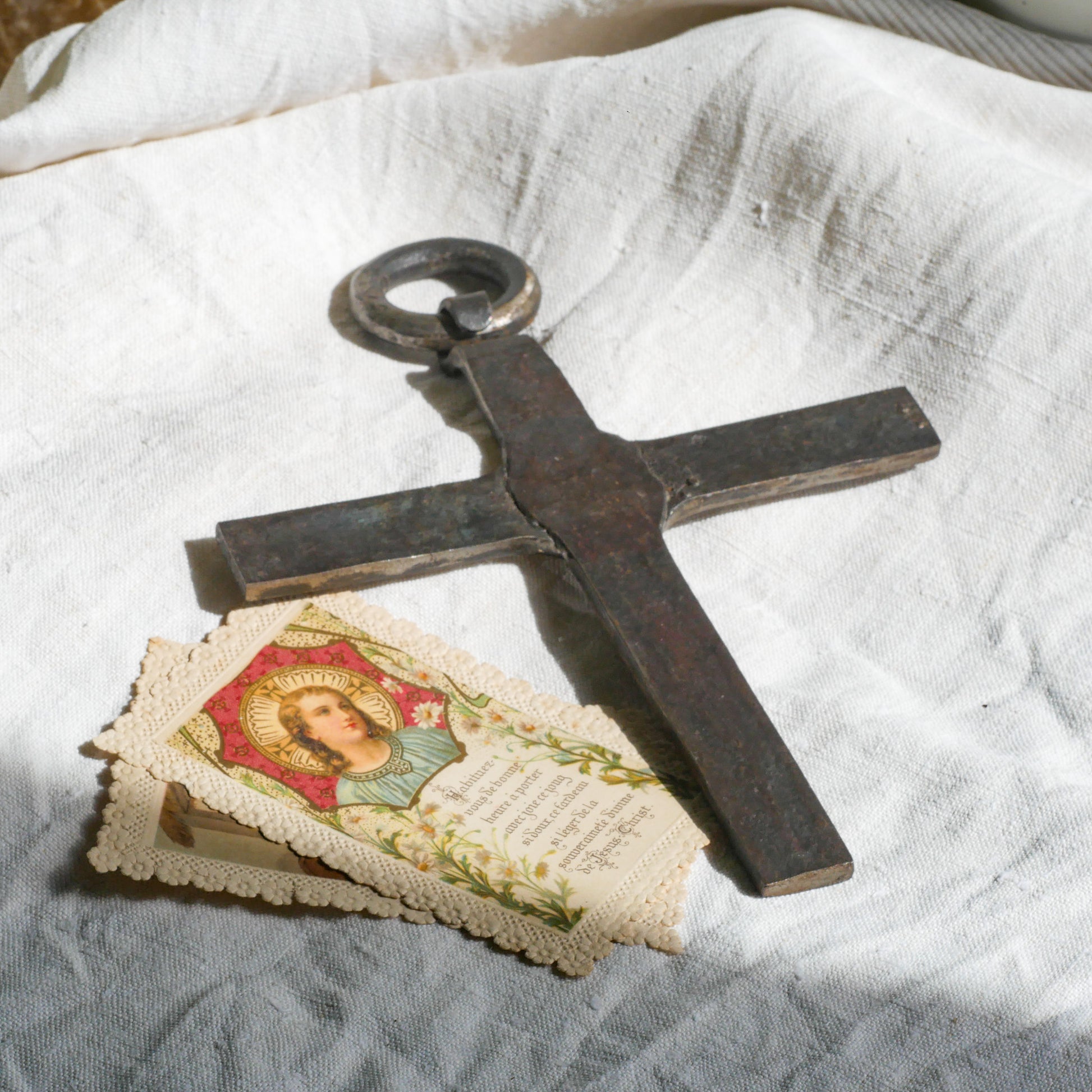 An interesting French antique artisan made Crucifix made from iron and painted black. On one side the metal has worn away in places giving this piece a pleasing patina of age. There's a hanging loop so it's ready to hang in your home.

We guesstimate this piece to be over 100 years old.