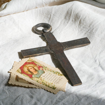 An interesting French antique artisan made Crucifix made from iron and painted black. On one side the metal has worn away in places giving this piece a pleasing patina of age. There's a hanging loop so it's ready to hang in your home.

We guesstimate this piece to be over 100 years old.