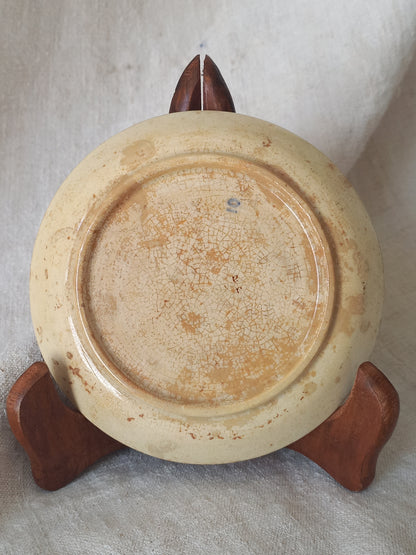 Close-up of the underneath of a ceramic plate with a tea-stained  surface.