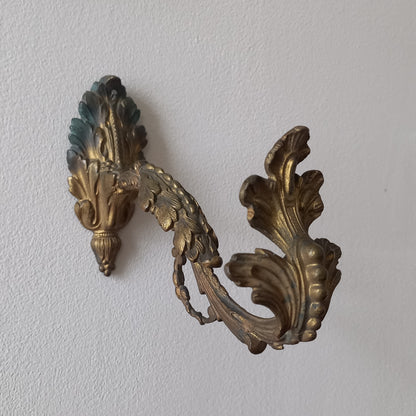 Decorative gold leaf design on a textured white surface