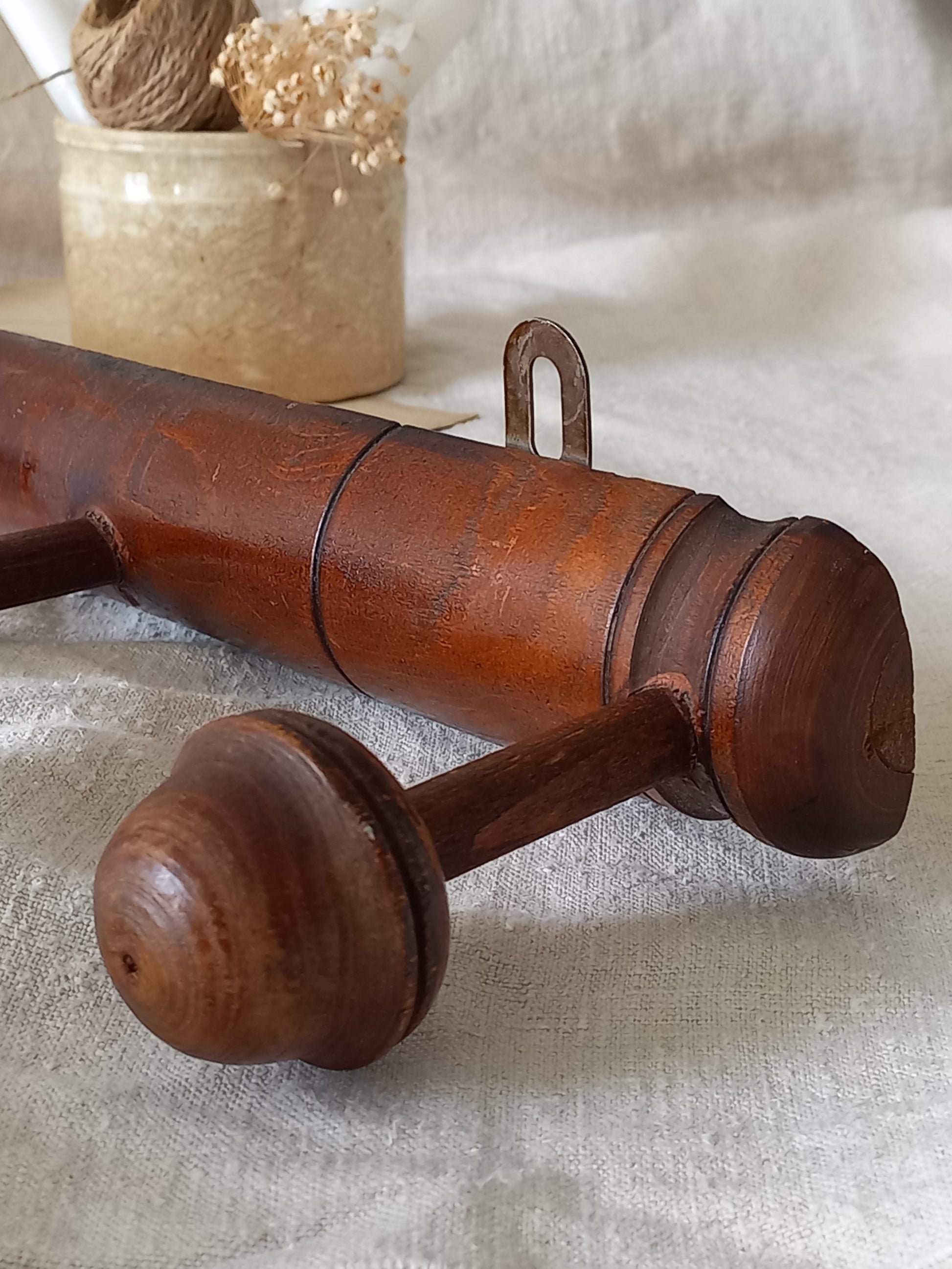 Close-up of a French vintage faux bamboo wooden coat rack with 5 hanging hooks/pegs.
