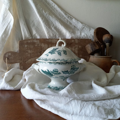 A small-sized antique ironstone soup tureen by French manufacturer, St. Amand. This tureen is adorned with a beautiful teal coloured floral transferware pattern and has a splendid little handle on the lid. In summary, an elegant piece with just enough patina of age to give it character.