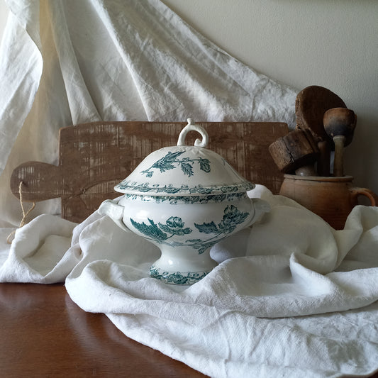 A small-sized antique ironstone soup tureen by French manufacturer, St. Amand. This tureen is adorned with a beautiful teal coloured floral transferware pattern and has a splendid little handle on the lid. In summary, an elegant piece with just enough patina of age to give it character.