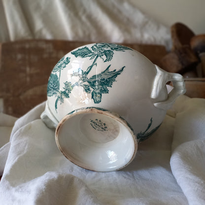 A small-sized antique ironstone soup tureen by French manufacturer, St. Amand. This tureen is adorned with a beautiful teal coloured floral transferware pattern and has a splendid little handle on the lid. In summary, an elegant piece with just enough patina of age to give it character.