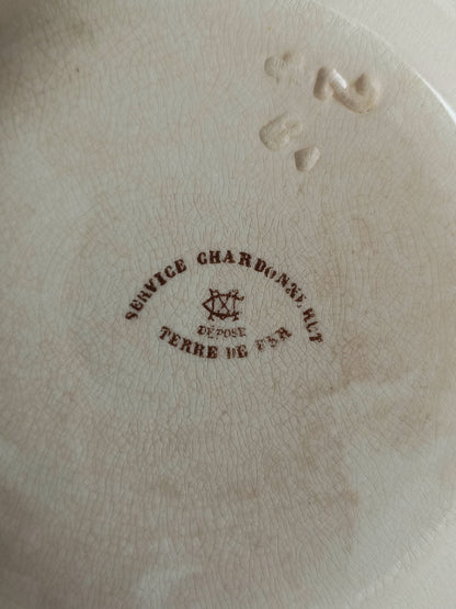 Close up of underneath of a French antique ironstone/earthenware bowl with sepia/brown bird pattern