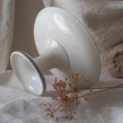 An attractive French antique footed ironstone cake plate with a blue transfer pattern depicting architecture, cherubs, and flowers; a very pretty and delicate pattern.

Original antique ironstone pieces of this age and condition are becoming increasingly difficult to source to this a rare treat to discover.
