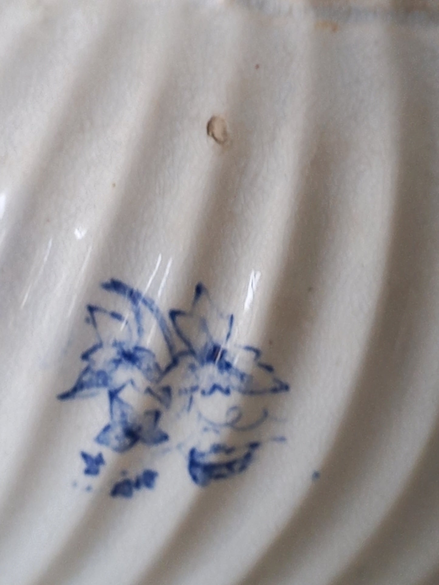 Close-up of a ceramic jug with blue floral design on a white background