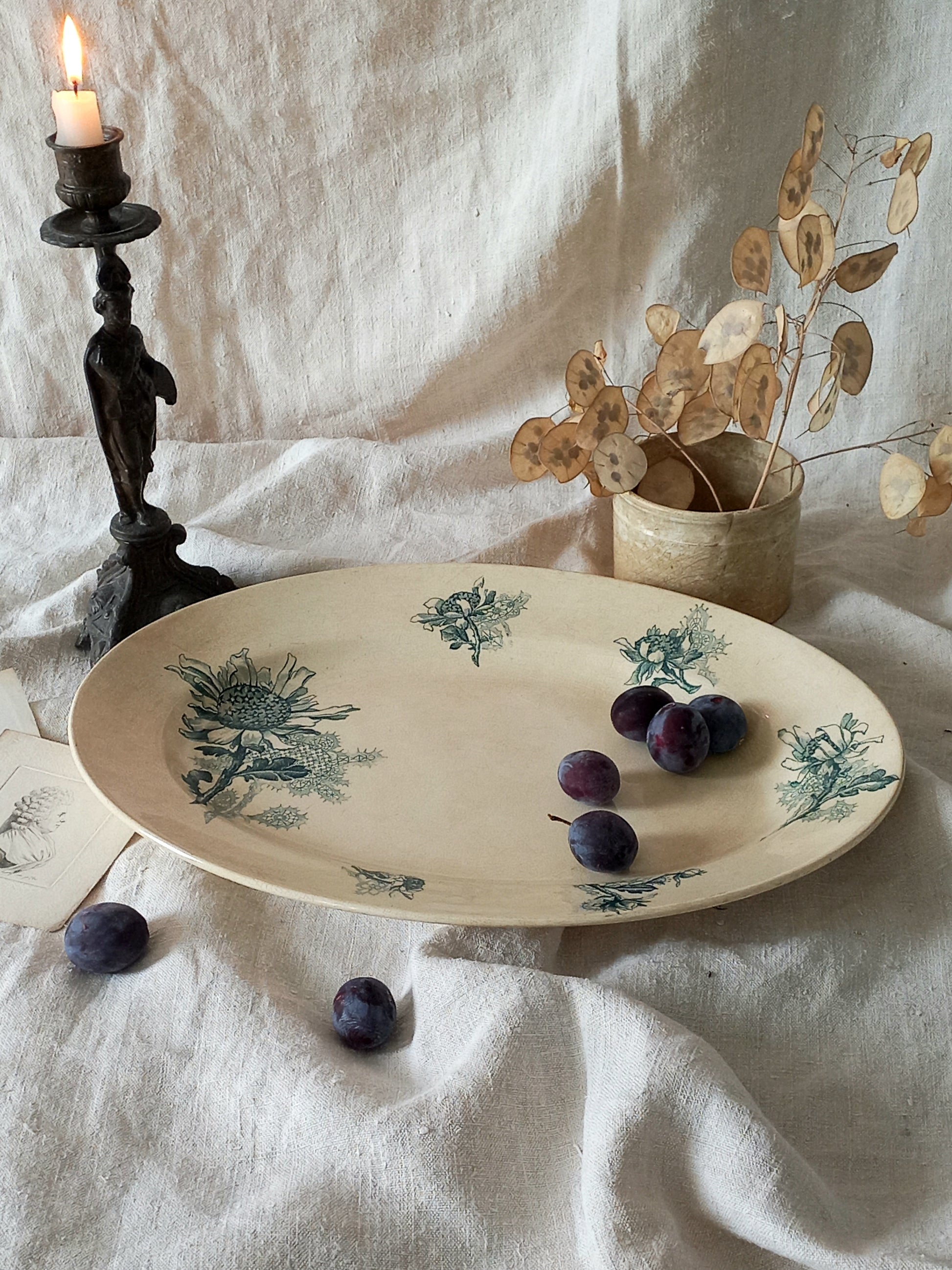 French antique oval ironstone serving plate with teal colour sunflower transferware pattern that over many decades has become a pleasing, warm shade of creamy white with crazing and tea-staining. 