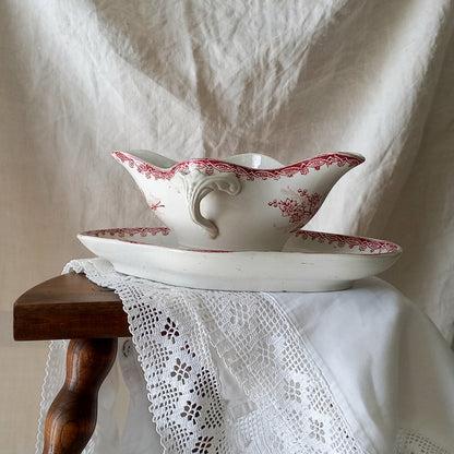 A beautiful French antique white ironstone gravy boat with a pretty pink floral transferware pattern, a heavy and quality piece manufactured by St. Amand. A great piece of decor in any home, and especially those of a rustic, country or farmhouse nature.