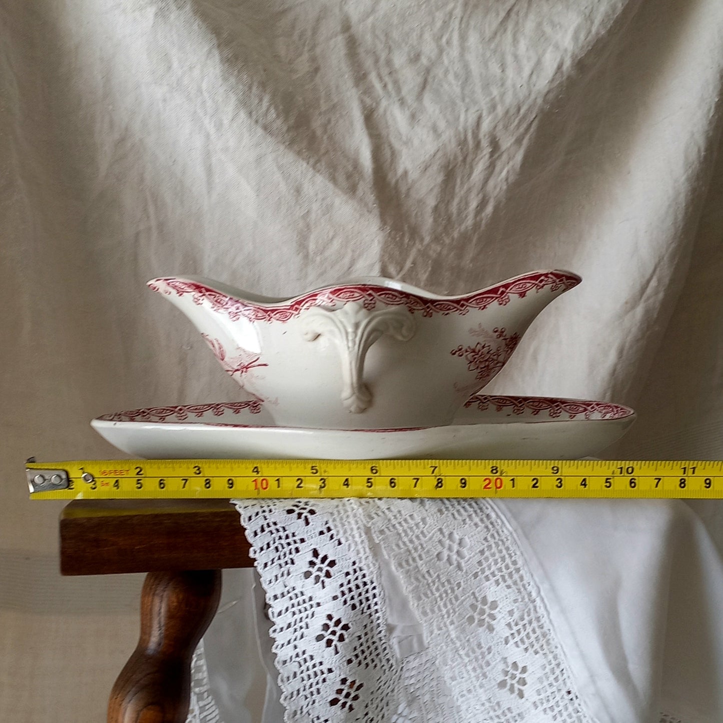 A beautiful French antique white ironstone gravy boat with a pretty pink floral transferware pattern, a heavy and quality piece manufactured by St. Amand. A great piece of decor in any home, and especially those of a rustic, country or farmhouse nature.