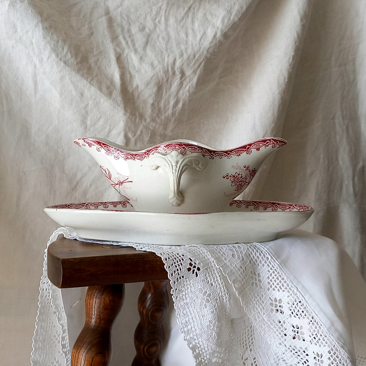A beautiful French antique white ironstone gravy boat with a pretty pink floral transferware pattern, a heavy and quality piece manufactured by St. Amand. A great piece of decor in any home, and especially those of a rustic, country or farmhouse nature.