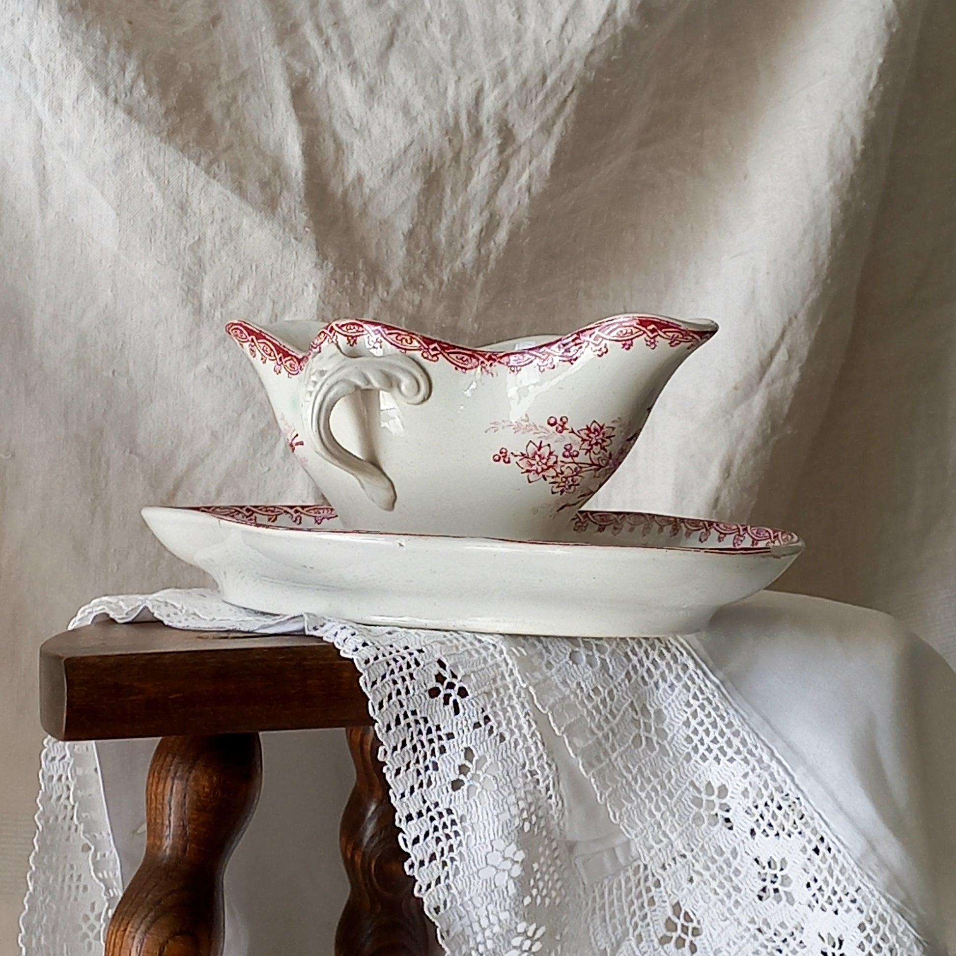 A beautiful French antique white ironstone gravy boat with a pretty pink floral transferware pattern, a heavy and quality piece manufactured by St. Amand. A great piece of decor in any home, and especially those of a rustic, country or farmhouse nature.