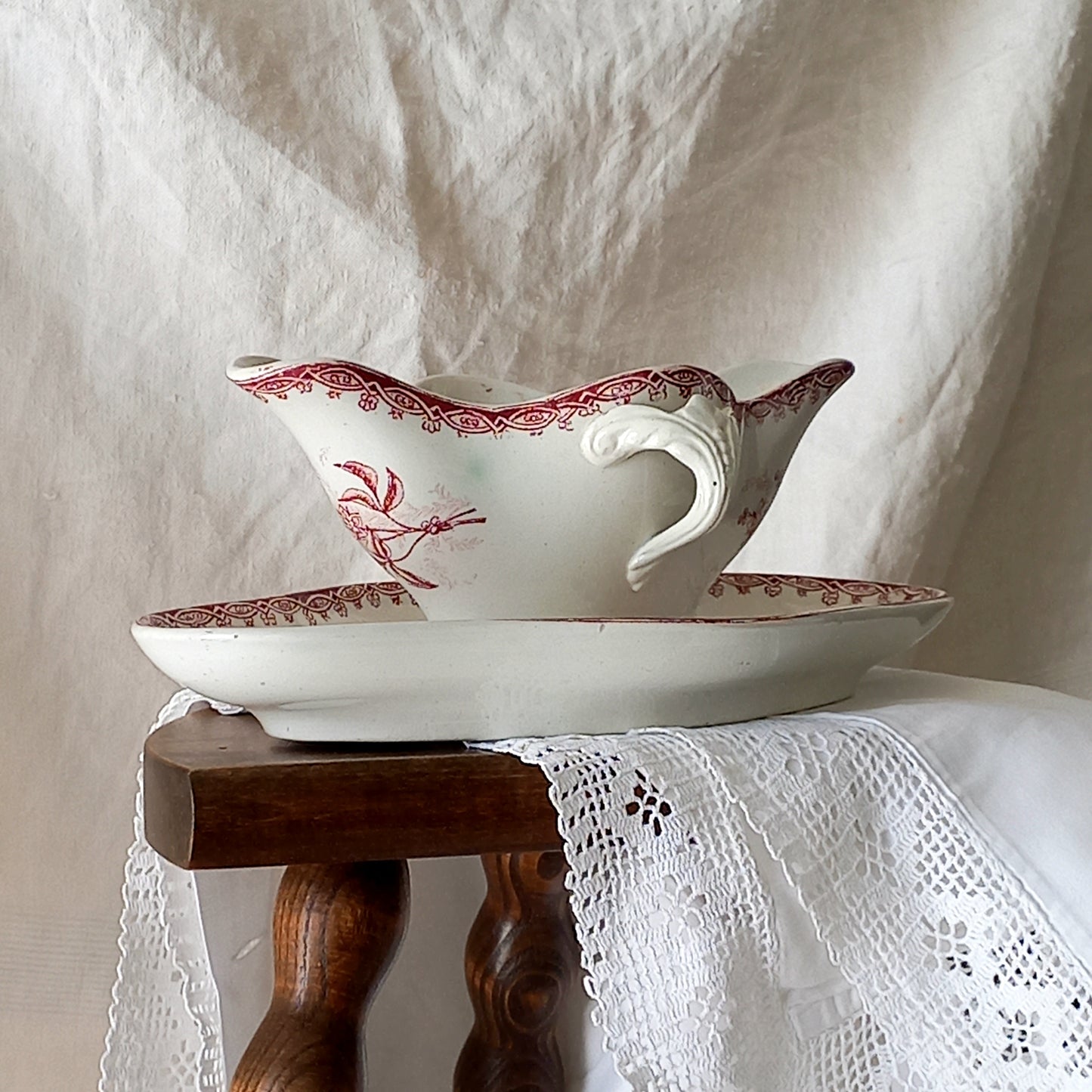 A beautiful French antique white ironstone gravy boat with a pretty pink floral transferware pattern, a heavy and quality piece manufactured by St. Amand. A great piece of decor in any home, and especially those of a rustic, country or farmhouse nature.