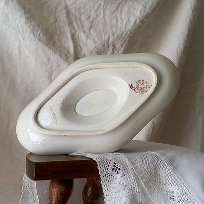 A beautiful French antique white ironstone gravy boat with a pretty pink floral transferware pattern, a heavy and quality piece manufactured by St. Amand. A great piece of decor in any home, and especially those of a rustic, country or farmhouse nature.