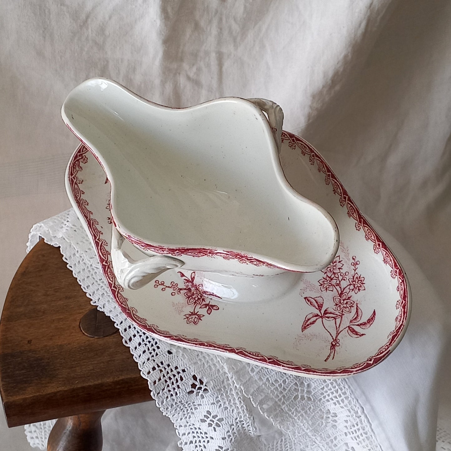 A beautiful French antique white ironstone gravy boat with a pretty pink floral transferware pattern, a heavy and quality piece manufactured by St. Amand. A great piece of decor in any home, and especially those of a rustic, country or farmhouse nature.