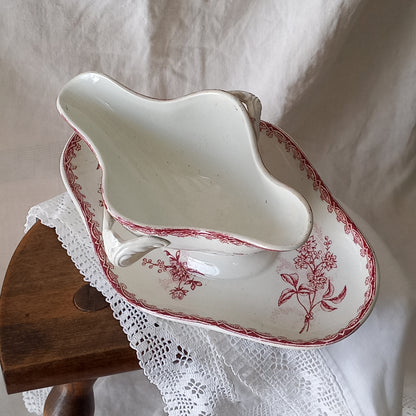 A beautiful French antique white ironstone gravy boat with a pretty pink floral transferware pattern, a heavy and quality piece manufactured by St. Amand. A great piece of decor in any home, and especially those of a rustic, country or farmhouse nature.