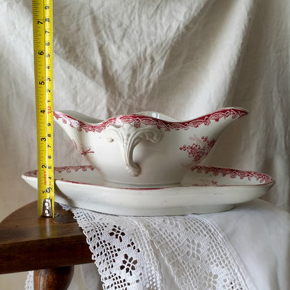 A beautiful French antique white ironstone gravy boat with a pretty pink floral transferware pattern, a heavy and quality piece manufactured by St. Amand. A great piece of decor in any home, and especially those of a rustic, country or farmhouse nature.