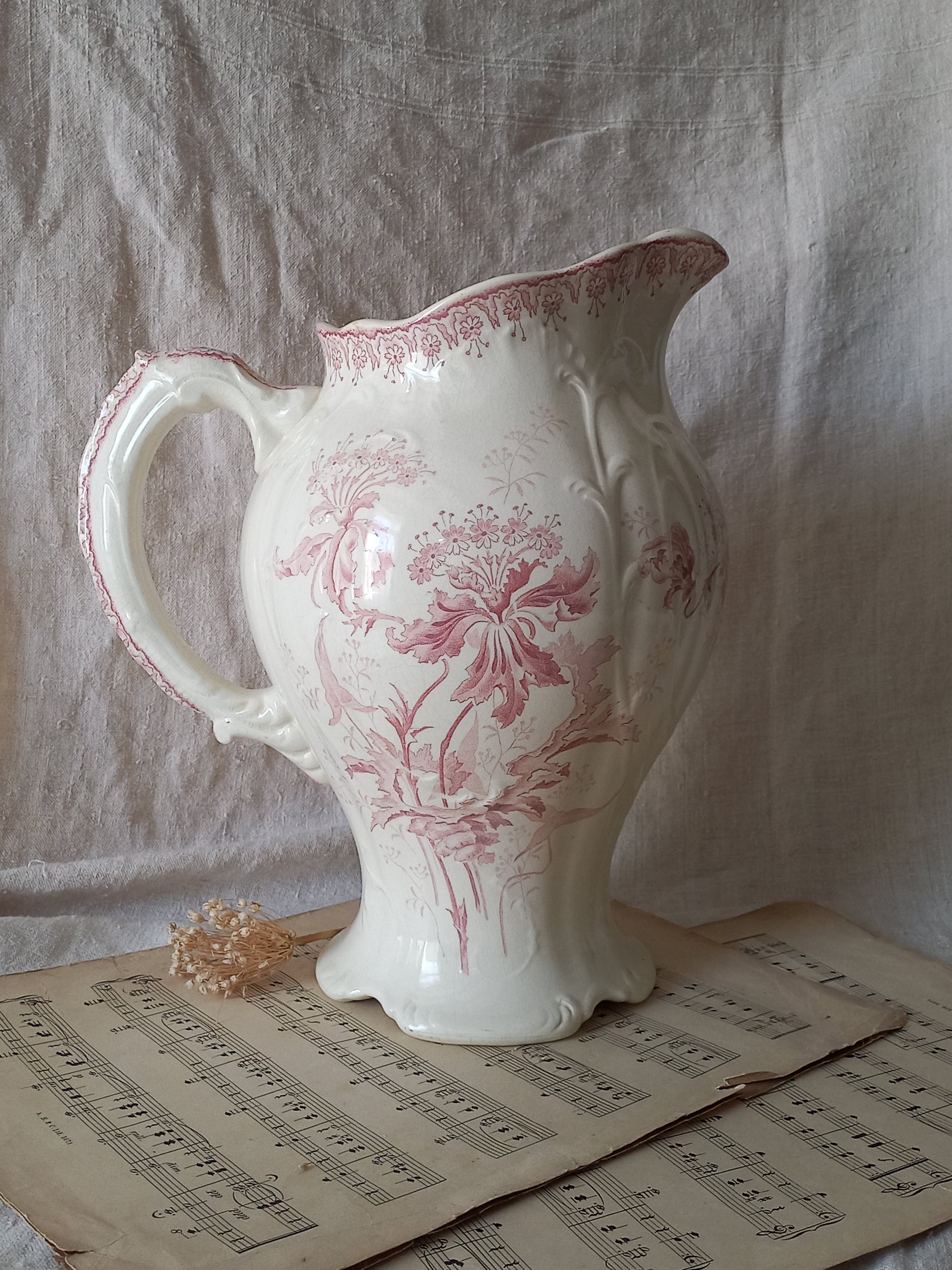 Large French antique ironstone jug in a decorative setting.