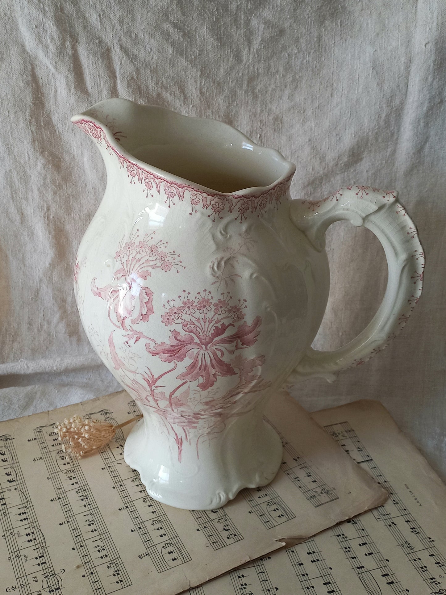 Large French antique ironstone jug in a decorative setting.