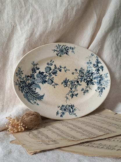 Decorative plate with blue floral patterns on a light fabric background