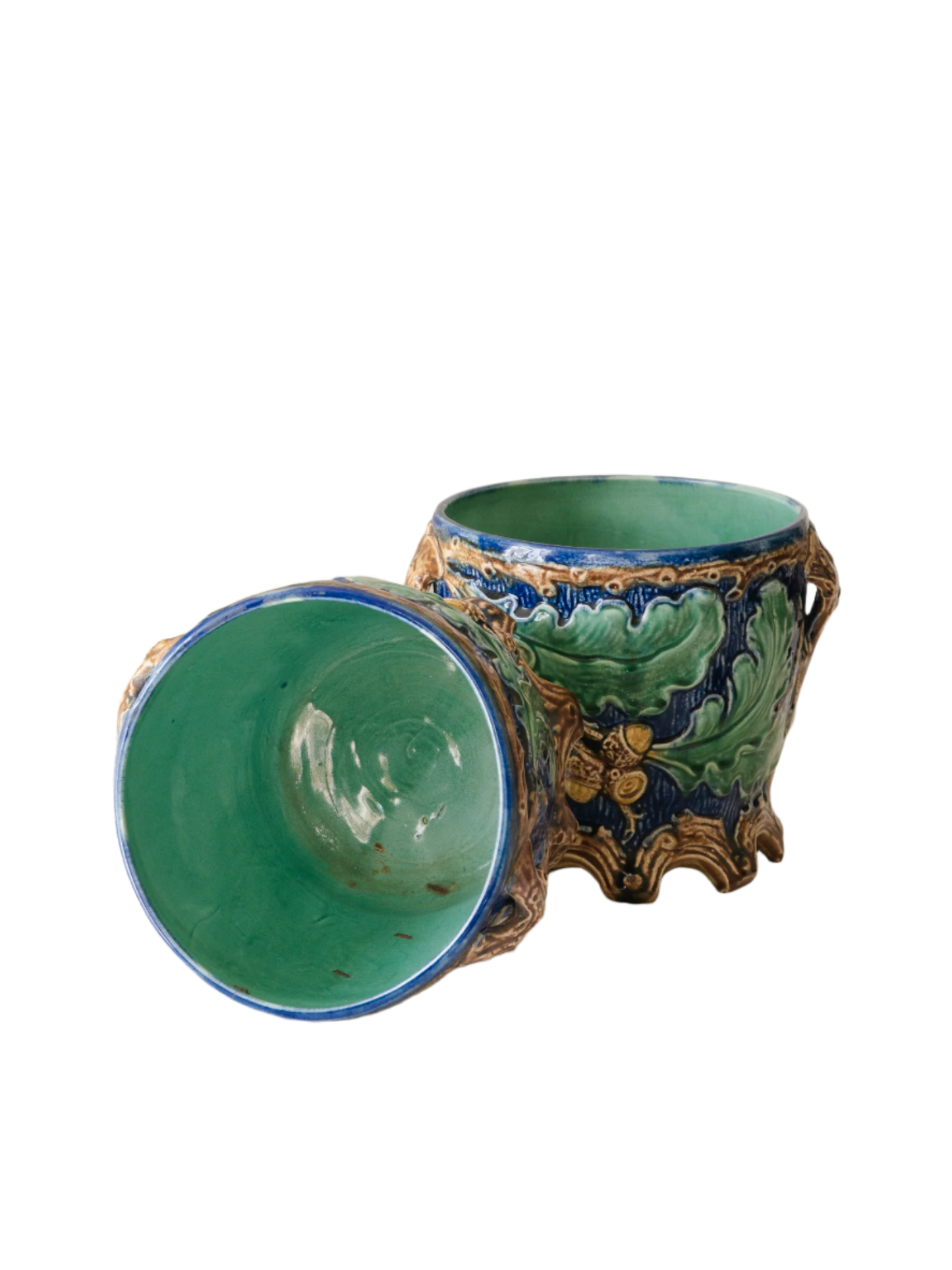 A stunning pair of French antique majolica planters, absolutely glorious fresh blue and green colours with oak leafs and acorns in relief making these stunning pieces of interior home decor wherever you decide to display them.

One of the planters has an antique repair in the form of metal staples that have been expertly done from the inside - in the 1800s and early 1900s this was quite a common repair to have made on items of high value and we feel it only adds to the authenticity/story of these pieces.