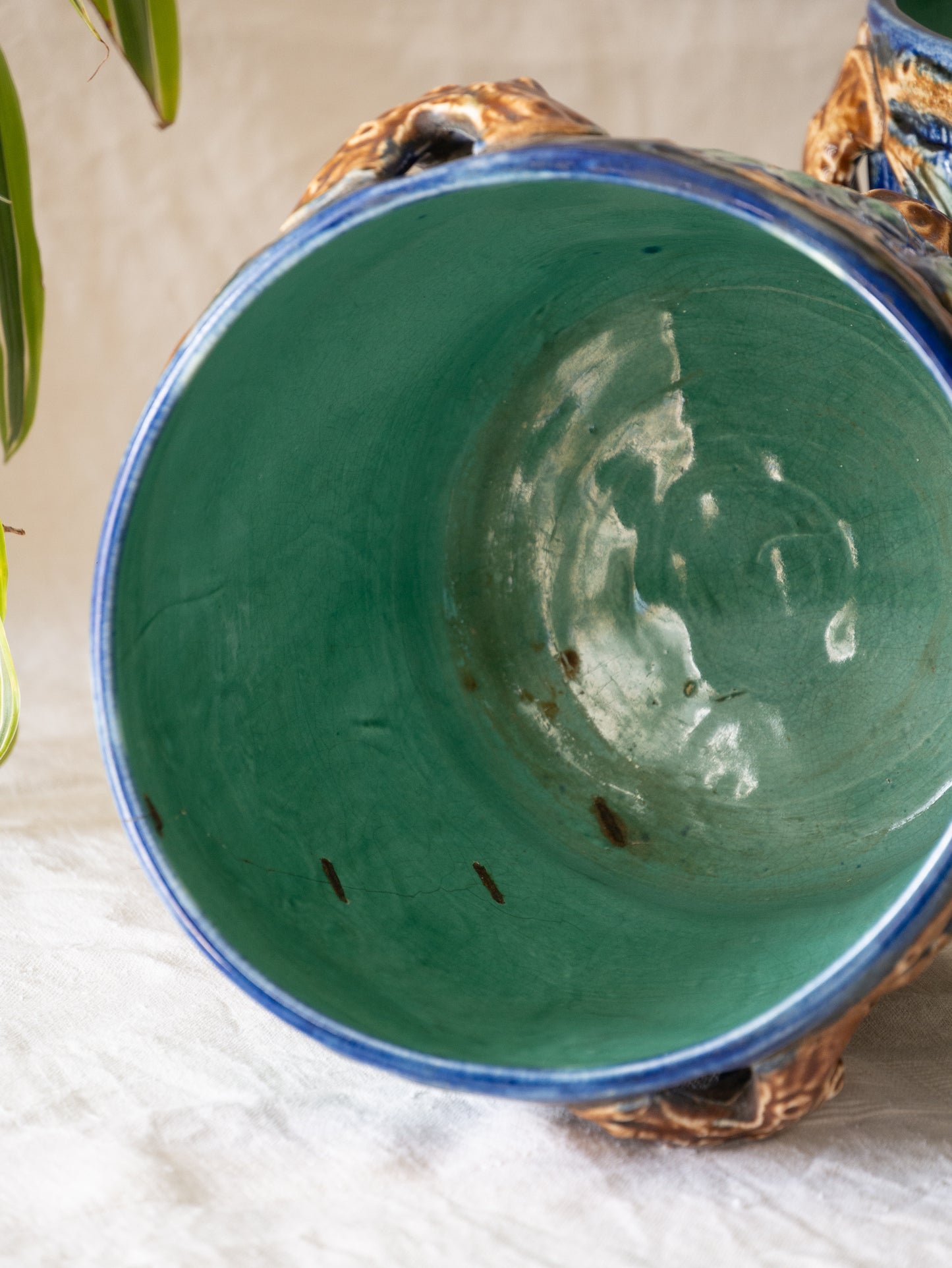 A stunning pair of French antique majolica planters, absolutely glorious fresh blue and green colours with oak leafs and acorns in relief making these stunning pieces of interior home decor wherever you decide to display them.

One of the planters has an antique repair in the form of metal staples that have been expertly done from the inside - in the 1800s and early 1900s this was quite a common repair to have made on items of high value and we feel it only adds to the authenticity/story of these pieces.