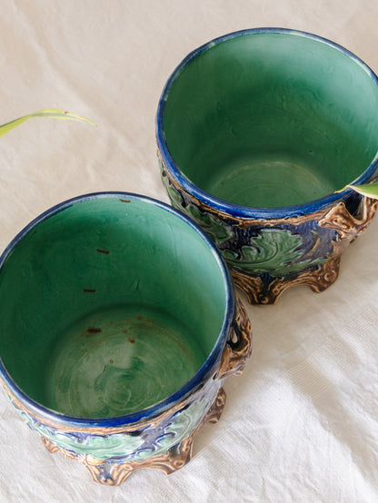 A stunning pair of French antique majolica planters, absolutely glorious fresh blue and green colours with oak leafs and acorns in relief making these stunning pieces of interior home decor wherever you decide to display them.

One of the planters has an antique repair in the form of metal staples that have been expertly done from the inside - in the 1800s and early 1900s this was quite a common repair to have made on items of high value and we feel it only adds to the authenticity/story of these pieces.