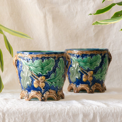 A stunning pair of French antique majolica planters, absolutely glorious fresh blue and green colours with oak leafs and acorns in relief making these stunning pieces of interior home decor wherever you decide to display them.

One of the planters has an antique repair in the form of metal staples that have been expertly done from the inside - in the 1800s and early 1900s this was quite a common repair to have made on items of high value and we feel it only adds to the authenticity/story of these pieces.