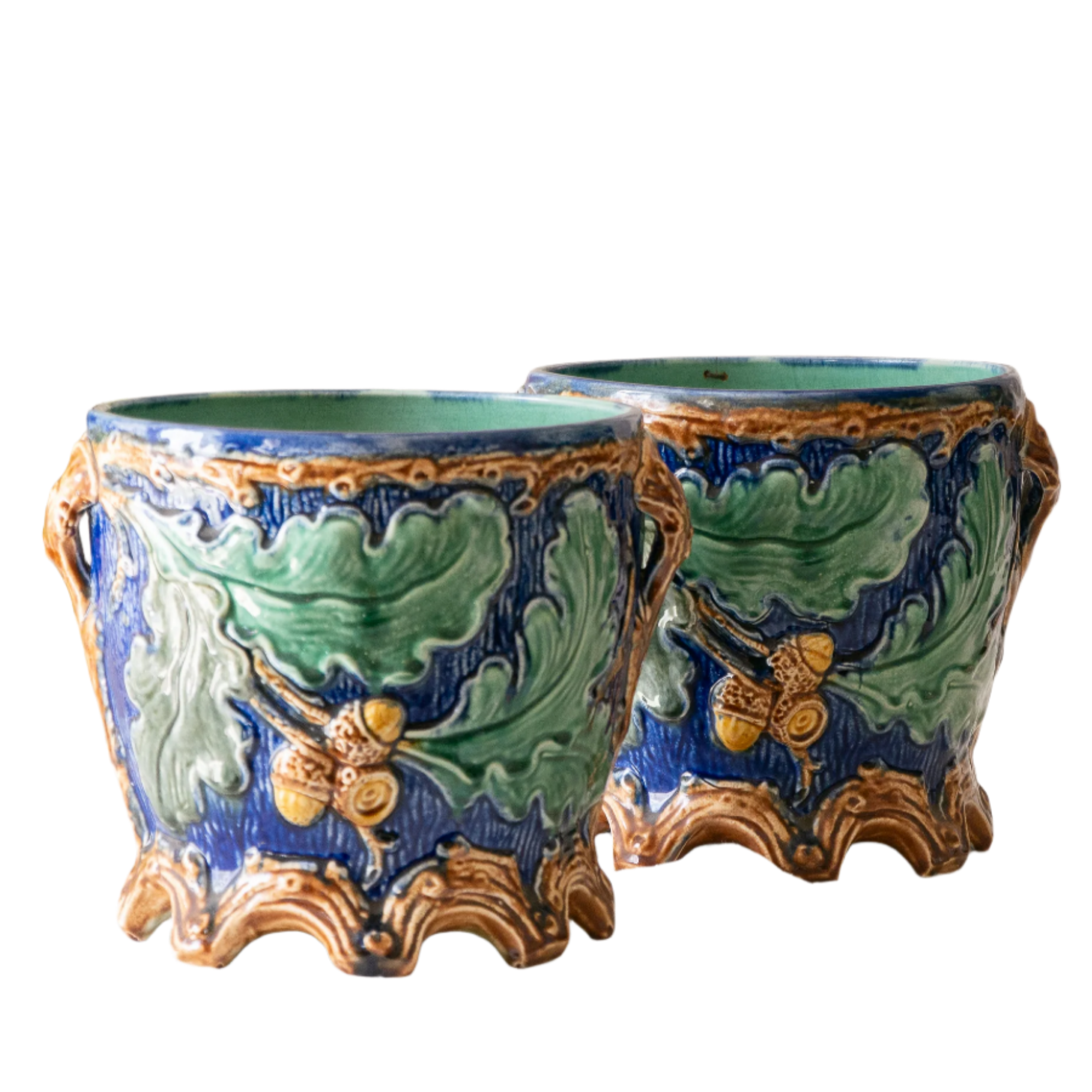 A stunning pair of French antique majolica planters, absolutely glorious fresh blue and green colours with oak leafs and acorns in relief making these stunning pieces of interior home decor wherever you decide to display them.

One of the planters has an antique repair in the form of metal staples that have been expertly done from the inside - in the 1800s and early 1900s this was quite a common repair to have made on items of high value and we feel it only adds to the authenticity/story of these pieces.