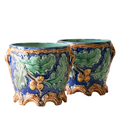 A stunning pair of French antique majolica planters, absolutely glorious fresh blue and green colours with oak leafs and acorns in relief making these stunning pieces of interior home decor wherever you decide to display them.

One of the planters has an antique repair in the form of metal staples that have been expertly done from the inside - in the 1800s and early 1900s this was quite a common repair to have made on items of high value and we feel it only adds to the authenticity/story of these pieces.