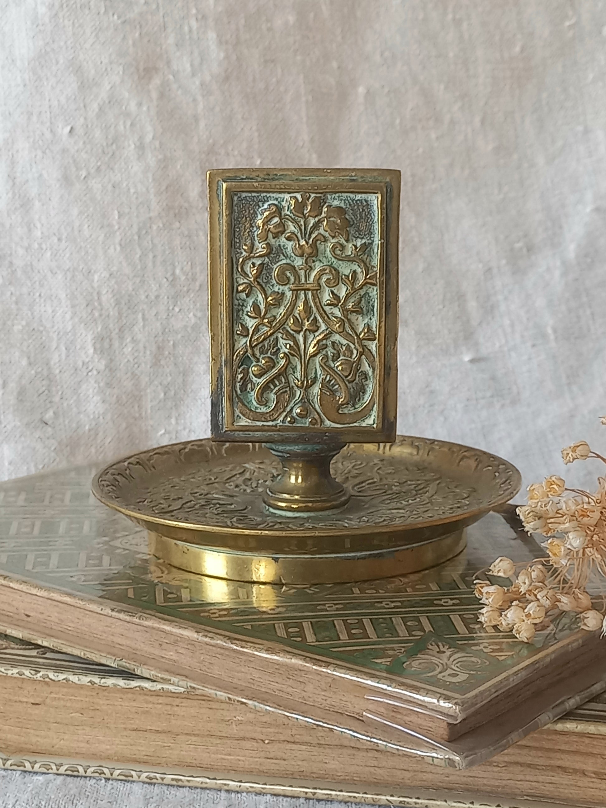 French antique decorative brass-coated matchbox holder in a decorative setting.