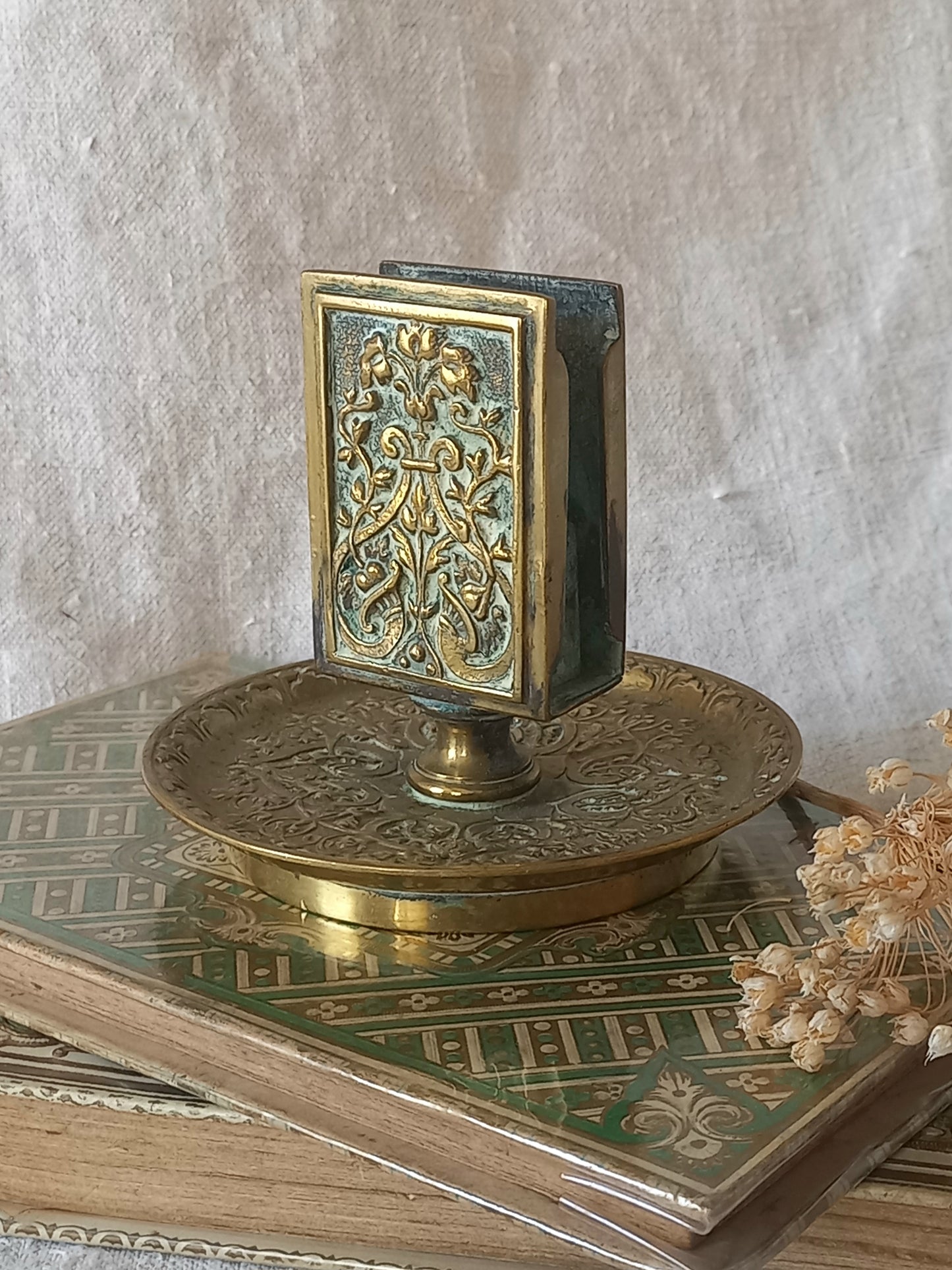 French antique decorative brass-coated matchbox holder in a decorative setting.