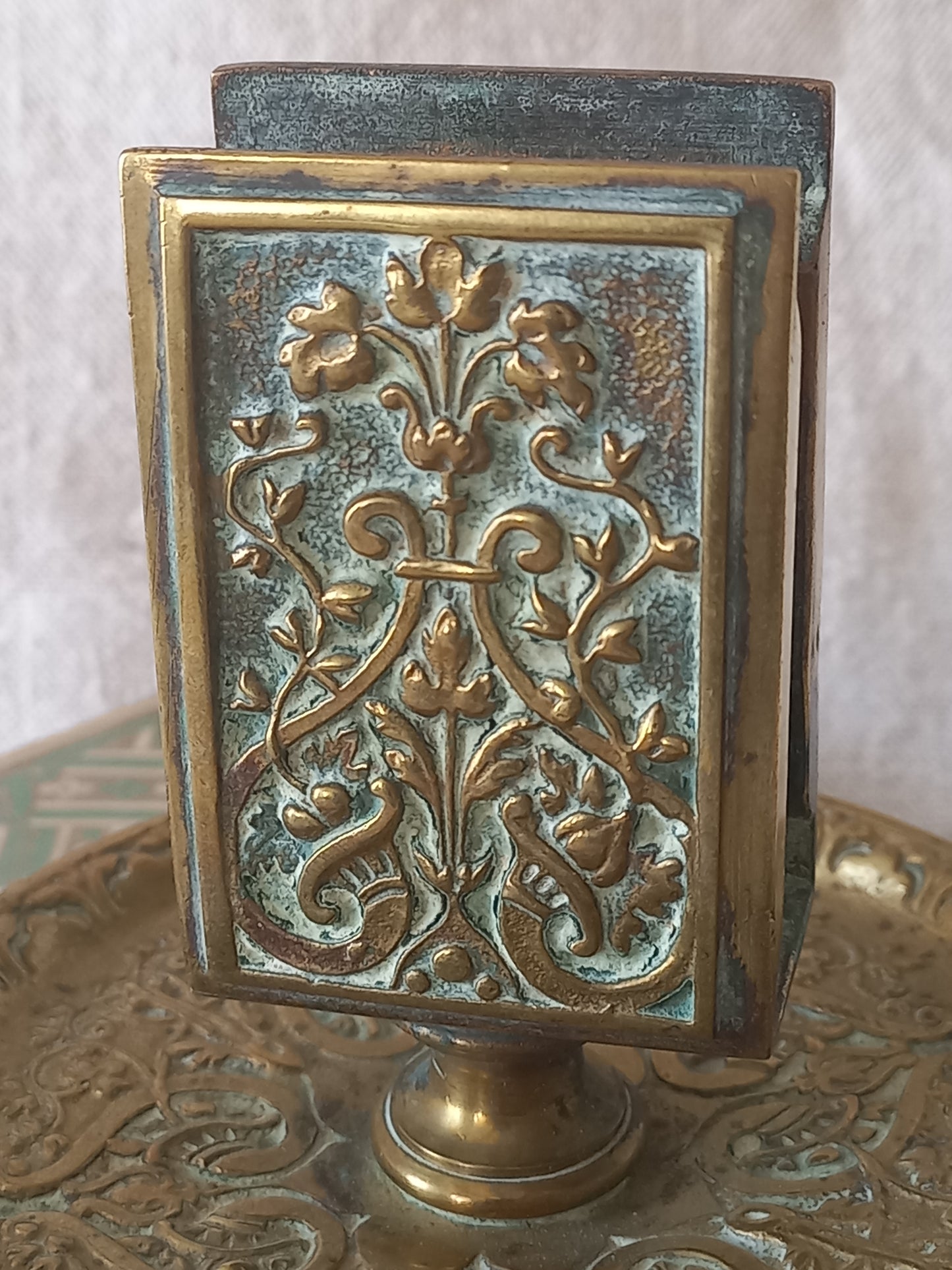 French antique decorative brass-coated matchbox holder in a decorative setting.
