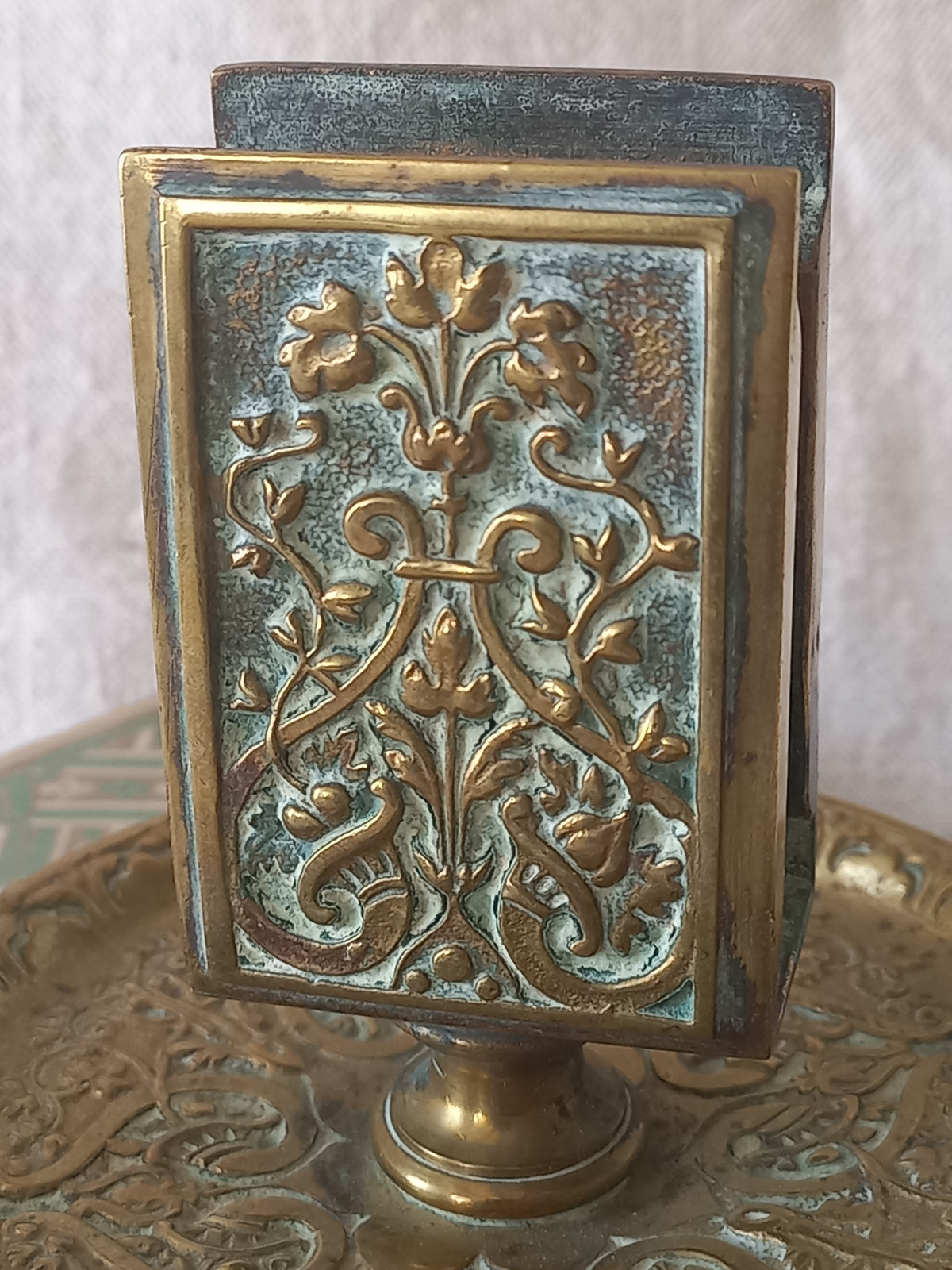 French antique decorative brass-coated matchbox holder in a decorative setting.