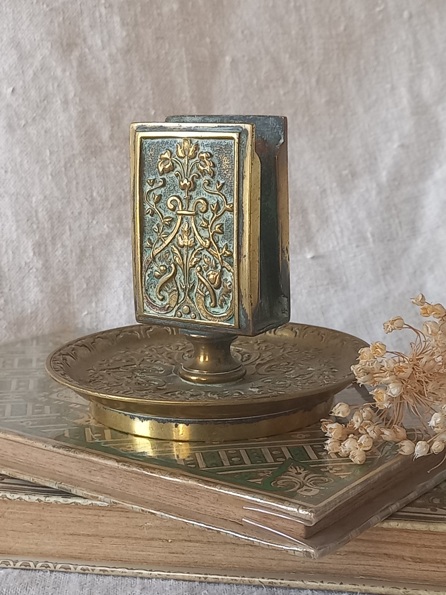 French antique decorative brass-coated matchbox holder in a decorative setting.