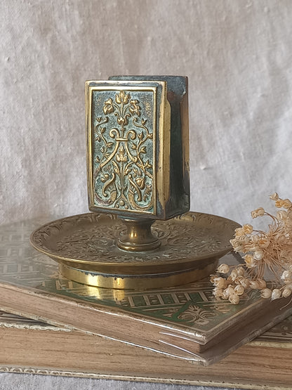 French antique decorative brass-coated matchbox holder in a decorative setting.