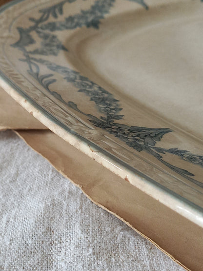 Close-up of a ceramic plate with floral patterns on a textured surface