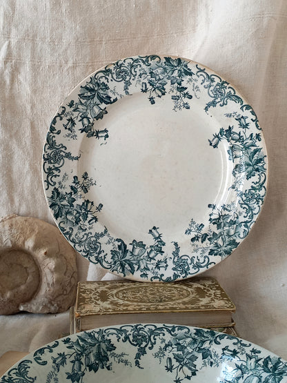Decorative plate with teal floral pattern on a beige background