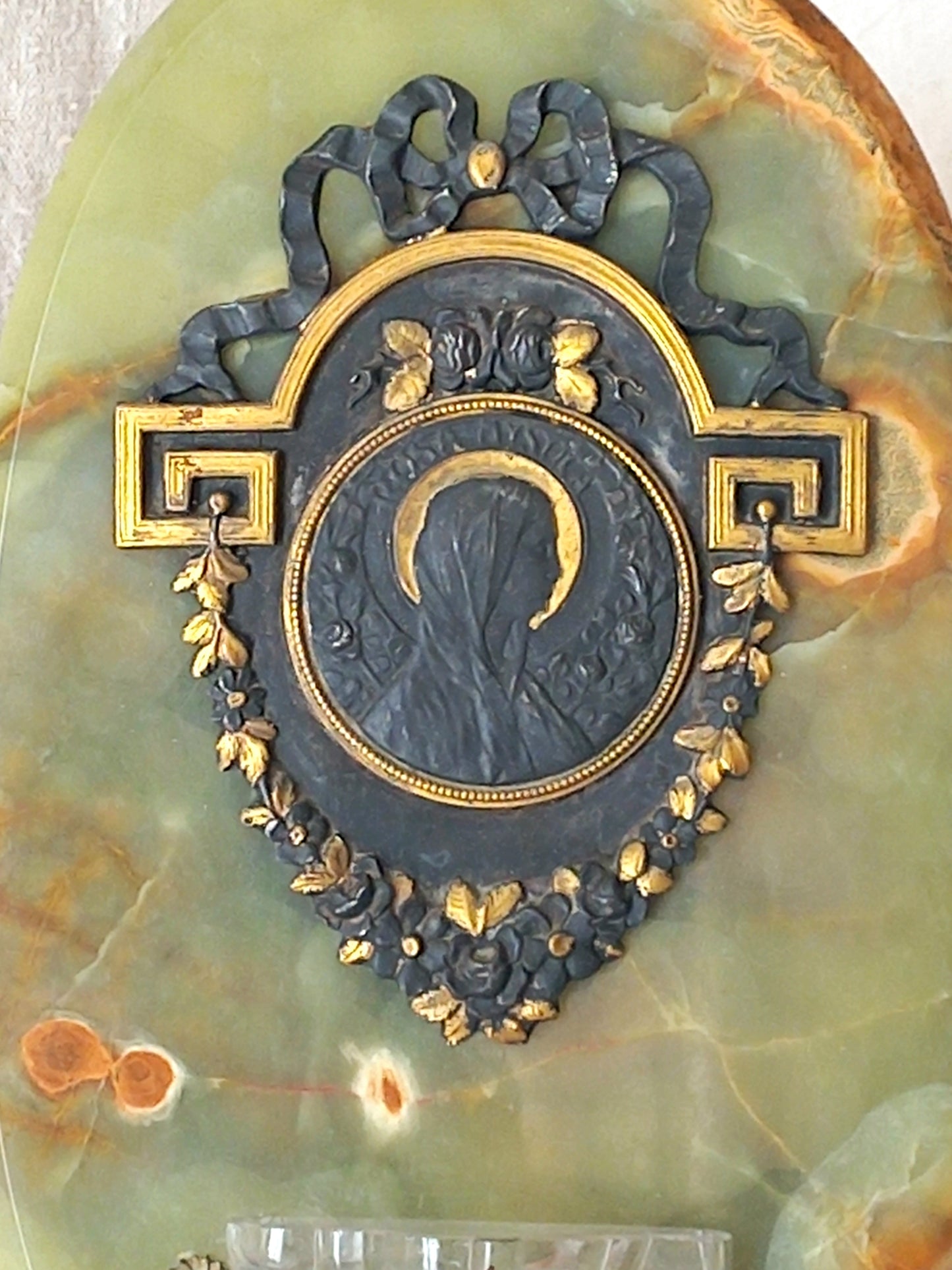 French antique Holy Water font made from onyx with intricate decorative detailing made from metal, a glass water font , and a brass back-plate with a hanging hook.