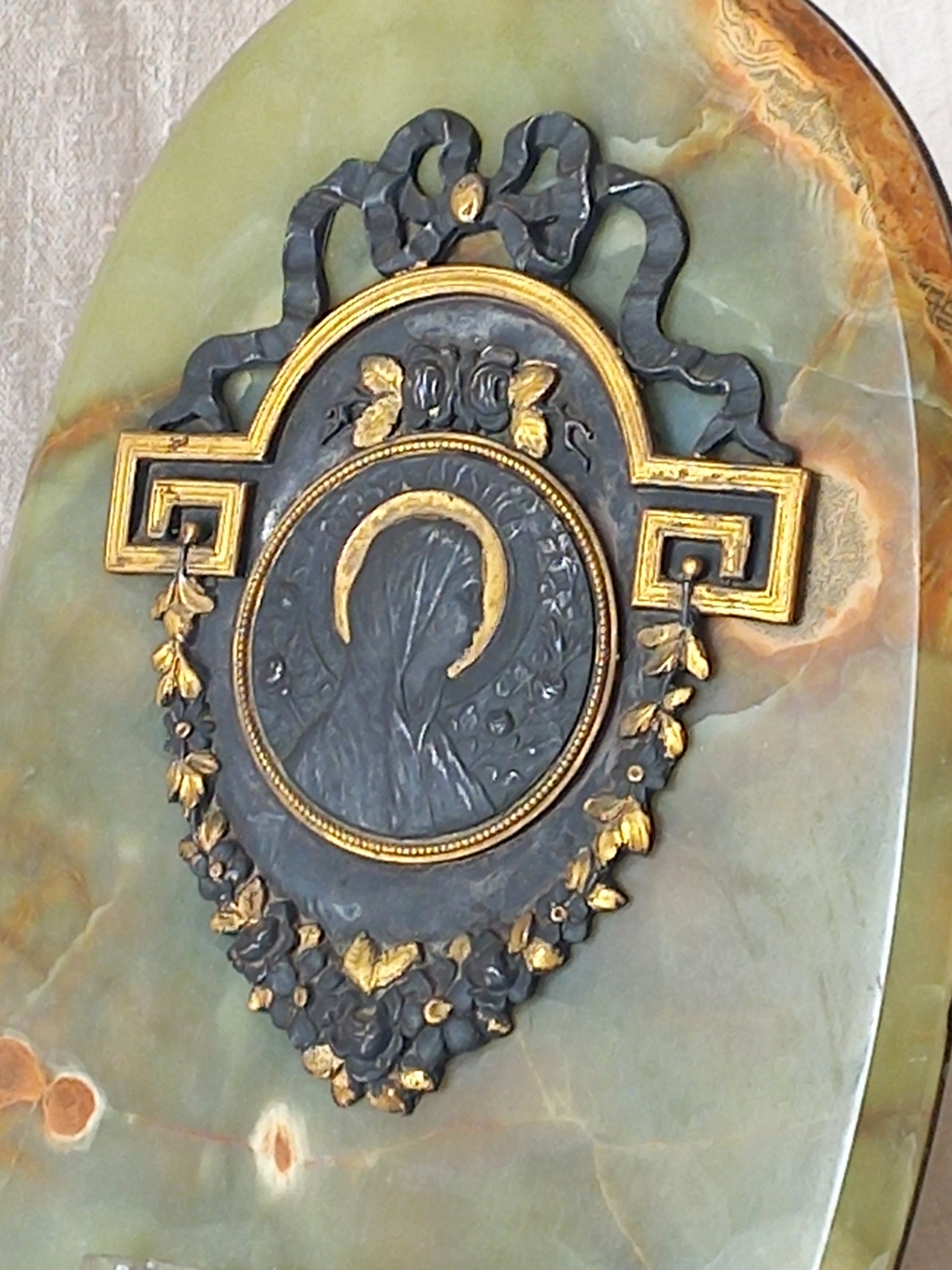 French antique Holy Water font made from onyx with intricate decorative detailing made from metal, a glass water font , and a brass back-plate with a hanging hook.