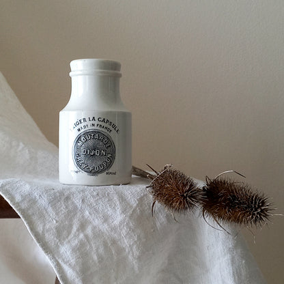 A small antique white ironstone Dijon Grey-Poupon mustard pot made by premier French manufacturer Sarreguemines. These little pots are very collectible and make wonderful pieces of home decor.