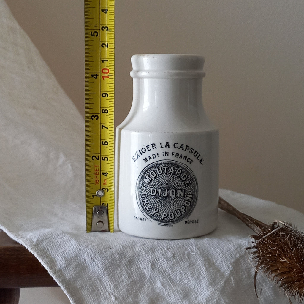 A small antique white ironstone Dijon Grey-Poupon mustard pot made by premier French manufacturer Sarreguemines. These little pots are very collectible and make wonderful pieces of home decor.