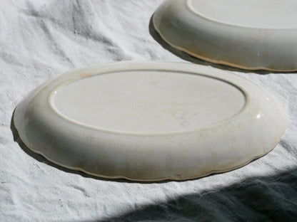 A beautiful pair of French antique ironstone raviers or side plates which over the last century or more have developed a wonderful time-worn and tea-stained finish which make them perfect for shabby chic interior decor. We very rarely come across these little plates lately they're a rare find.