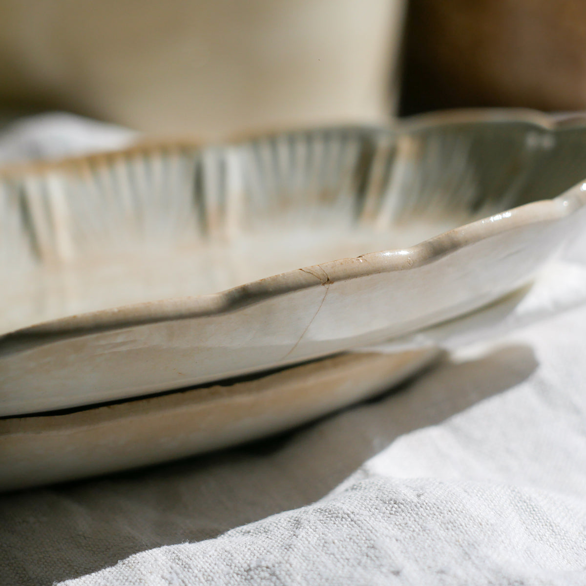 A beautiful pair of French antique ironstone raviers or side plates which over the last century or more have developed a wonderful time-worn and tea-stained finish which make them perfect for shabby chic interior decor. We very rarely come across these little plates lately they're a rare find.
